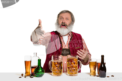 Image of Expert barman with beer at studio