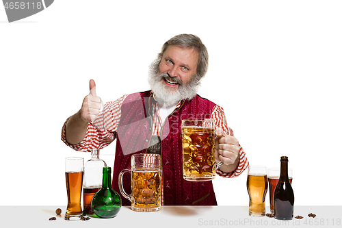 Image of Expert barman with beer at studio