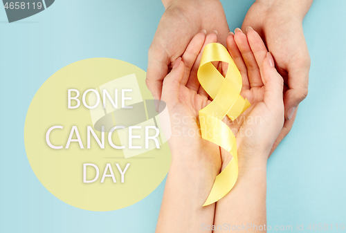 Image of Yellow ribbon symbolic color for Sarcoma Bone cancer awareness and suicide prevention