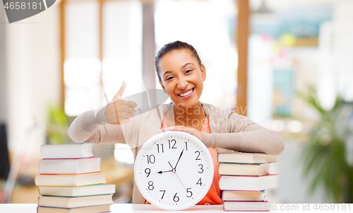 Image of african american student with clock and books