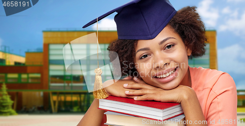 Image of african american graduate student with books