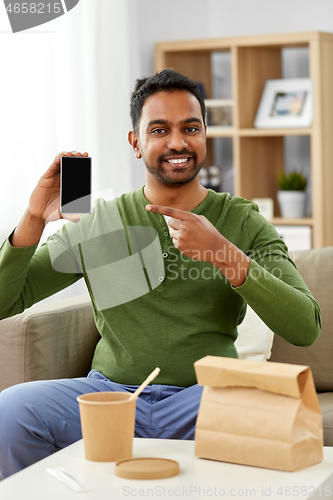 Image of indian man using smartphone for food delivery