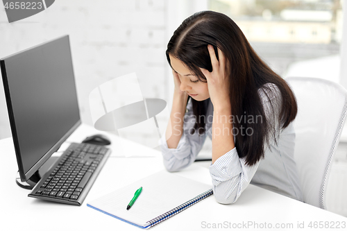 Image of stressed businesswoman with computer at office