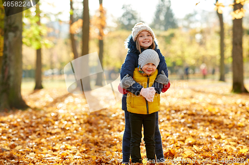 Image of happy children hugging at autumn park