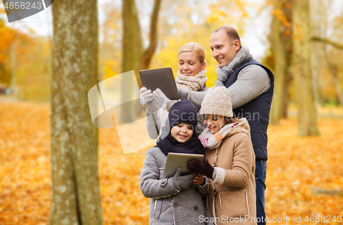 Image of happy family with tablet pc in autumn park