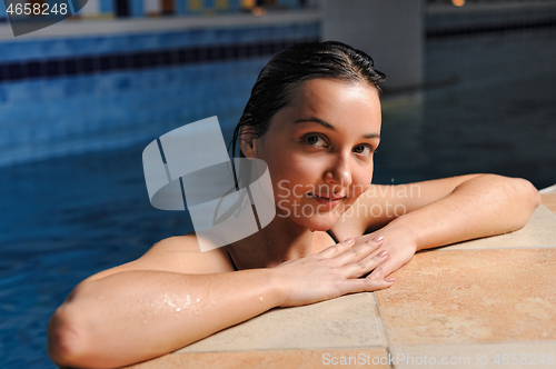 Image of woman at the edge of a swimming pool