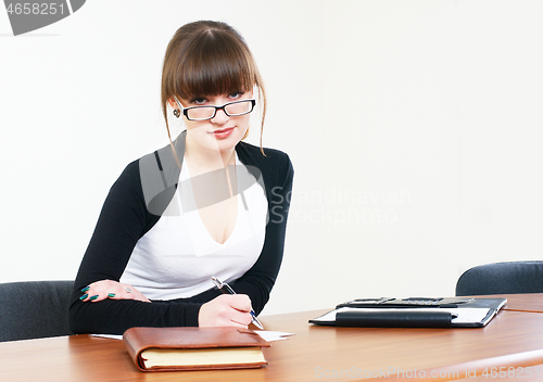 Image of Portrait of businesswoman with organizer