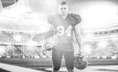 Image of American Football Player isolated on big modern stadium field