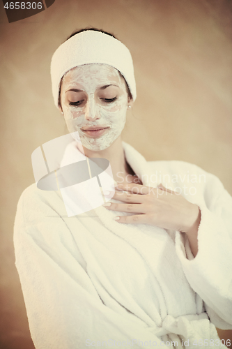 Image of woman in spa  with cosmetic mask