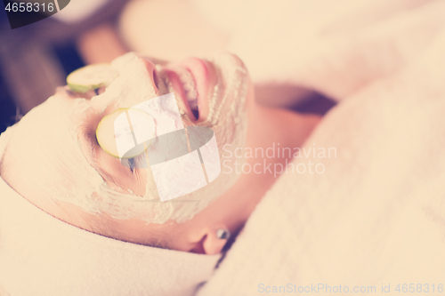 Image of woman in spa  with cosmetic mask