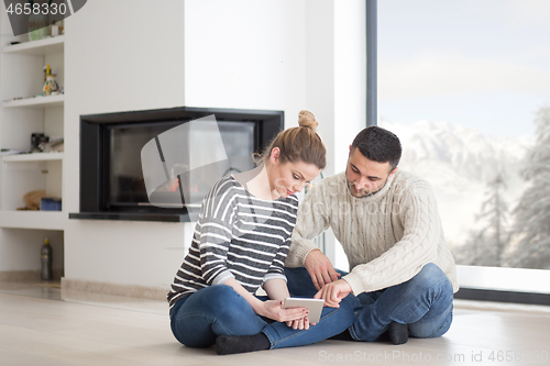 Image of Young Couple using digital tablet on cold winter day