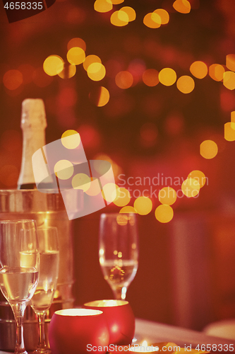 Image of champagne and glasses at home on christmas night