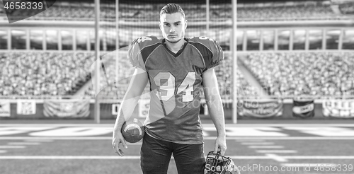 Image of American Football Player isolated on big modern stadium field