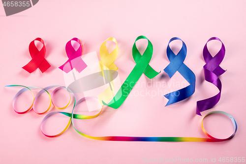 Image of World cancer dayon February 4. The colorful awareness ribbons on pink background