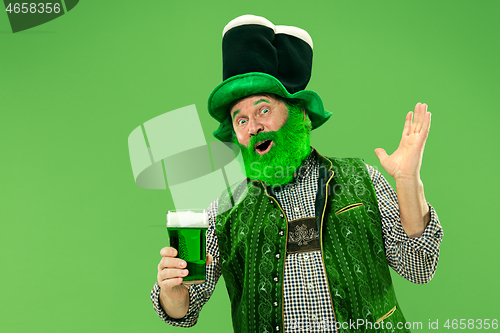 Image of A man in a leprechaun hat at studio. He celebrates St. Patrick\'s Day.