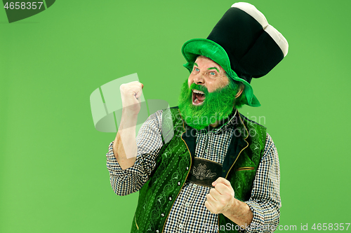 Image of A man in a leprechaun hat at studio. He celebrates St. Patrick\'s Day.