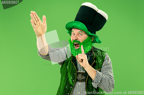 Image of A man in a leprechaun hat at studio. He celebrates St. Patrick\'s Day.