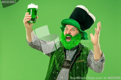 Image of A man in a leprechaun hat at studio. He celebrates St. Patrick\'s Day.