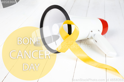 Image of Yellow ribbon symbolic color for Sarcoma Bone cancer awareness and suicide prevention