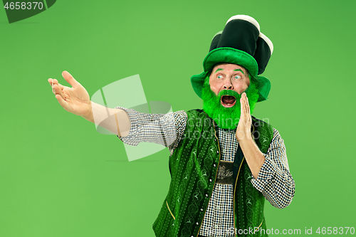 Image of A man in a leprechaun hat at studio. He celebrates St. Patrick\'s Day.