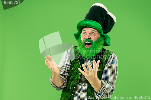 Image of A man in a leprechaun hat at studio. He celebrates St. Patrick\'s Day.