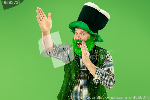 Image of A man in a leprechaun hat at studio. He celebrates St. Patrick\'s Day.