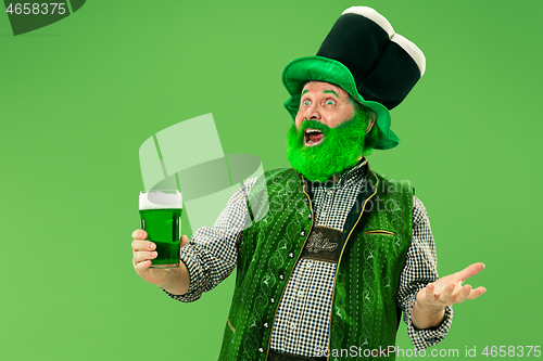 Image of A man in a leprechaun hat at studio. He celebrates St. Patrick\'s Day.