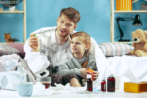 Image of Sick man with daughter at home. The ill family.