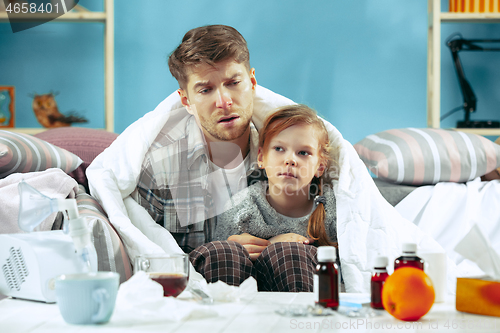 Image of Sick man with daughter at home. The ill family.