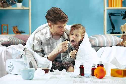 Image of Sick man with daughter at home. The ill family.