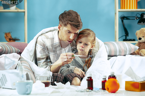 Image of Sick man with daughter at home. The ill family.