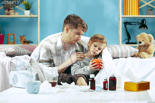 Image of Sick man with daughter at home. The ill family.