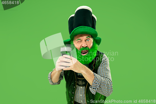 Image of A man in a leprechaun hat at studio. He celebrates St. Patrick\'s Day.