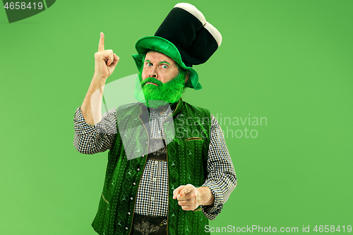 Image of A man in a leprechaun hat at studio. He celebrates St. Patrick\'s Day.