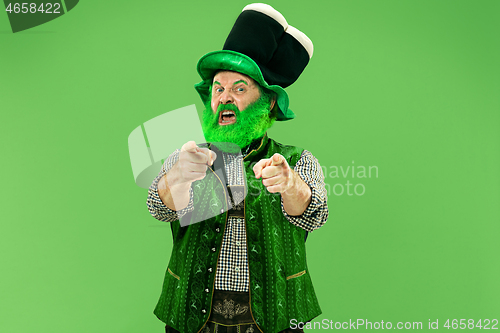 Image of A man in a leprechaun hat at studio. He celebrates St. Patrick\'s Day.