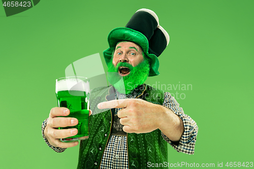 Image of A man in a leprechaun hat at studio. He celebrates St. Patrick\'s Day.