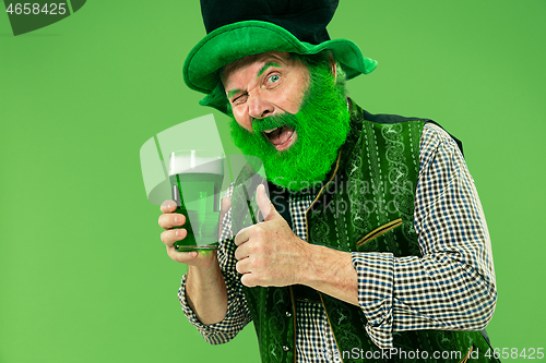 Image of A man in a leprechaun hat at studio. He celebrates St. Patrick\'s Day.