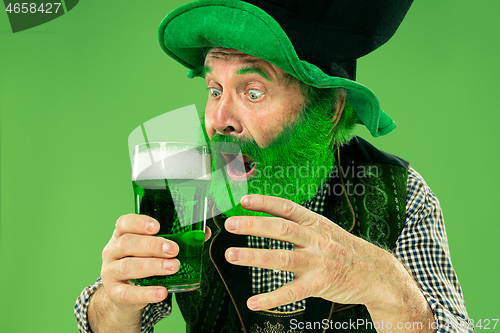 Image of A man in a leprechaun hat at studio. He celebrates St. Patrick\'s Day.