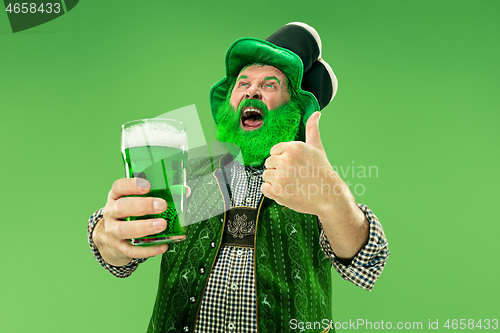 Image of A man in a leprechaun hat at studio. He celebrates St. Patrick\'s Day.