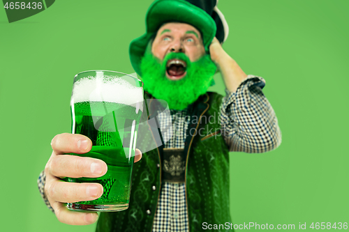 Image of A man in a leprechaun hat at studio. He celebrates St. Patrick\'s Day.