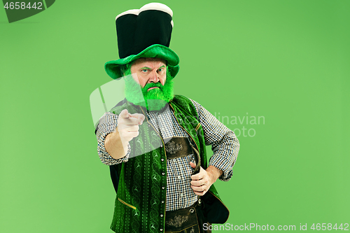 Image of A man in a leprechaun hat at studio. He celebrates St. Patrick\'s Day.