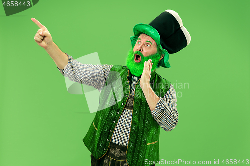 Image of A man in a leprechaun hat at studio. He celebrates St. Patrick\'s Day.