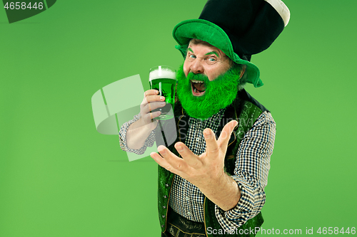 Image of A man in a leprechaun hat at studio. He celebrates St. Patrick\'s Day.