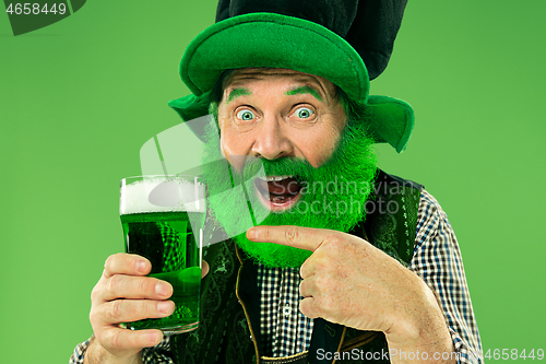 Image of A man in a leprechaun hat at studio. He celebrates St. Patrick\'s Day.