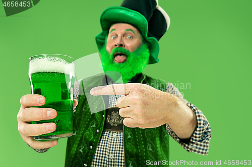 Image of A man in a leprechaun hat at studio. He celebrates St. Patrick\'s Day.