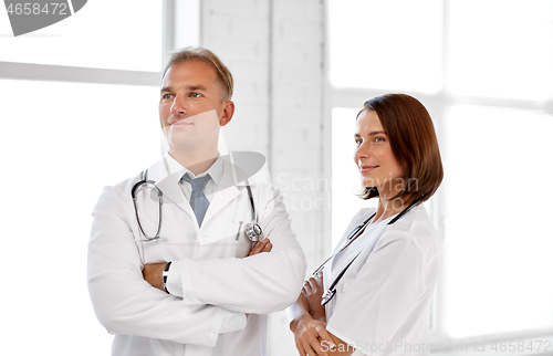 Image of smiling doctors in white coats at hospital