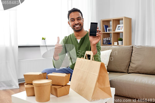 Image of indian man using smartphone for food delivery