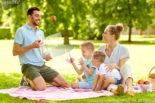 Image of happy family having picnic at summer park