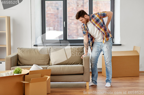 Image of man having back ache moving to new home