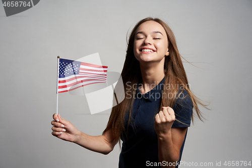Image of Happy female holding USA flag